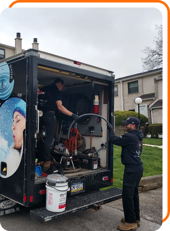 Horn Plumbing employees loading equipment into a work truck