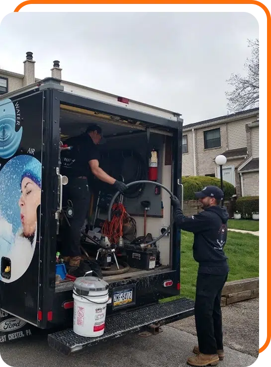 Horn Plumbing employees loading equipment into a work truck