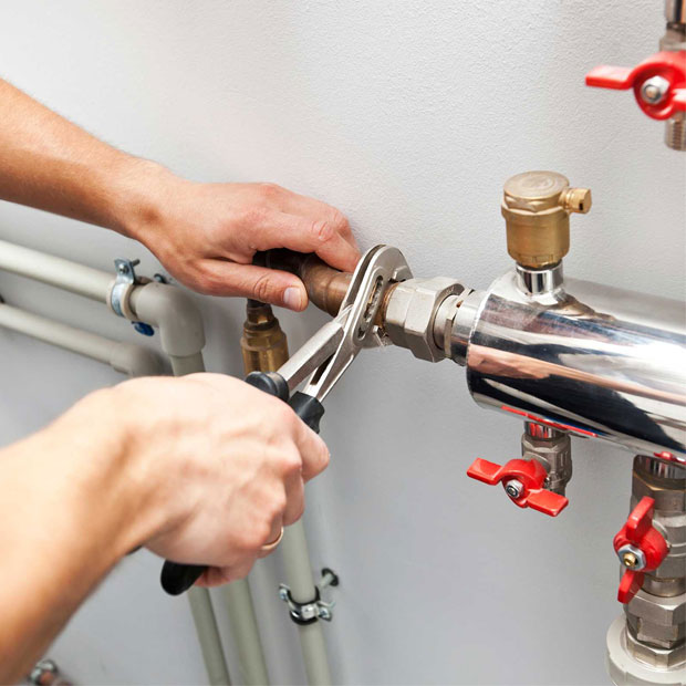 Person performing commercial plumbing repair