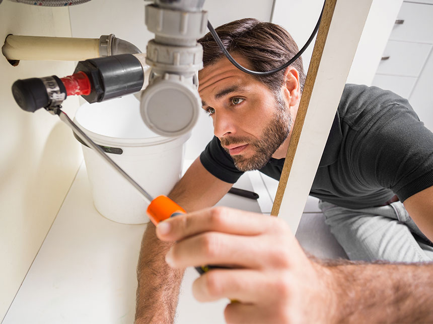 Plumbing inspector under sink